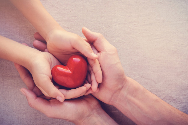adult-child-hands-holiding-red-heart-health-care-love-give-hope-family-concept_49149-13